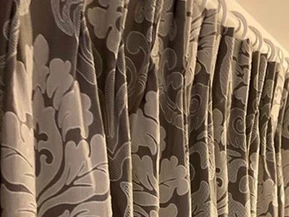 Grey curtain with white detail pattern and white pole