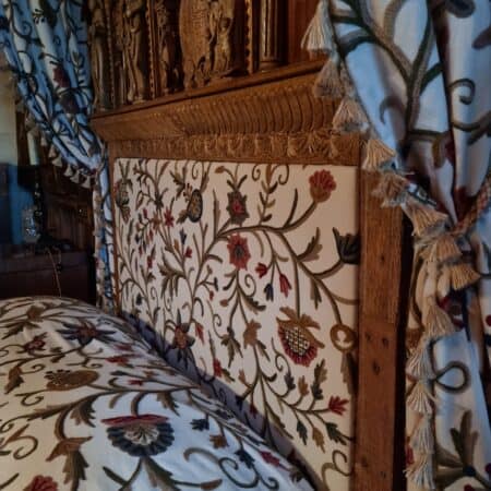Upholstered patterned headboard with matching bedding