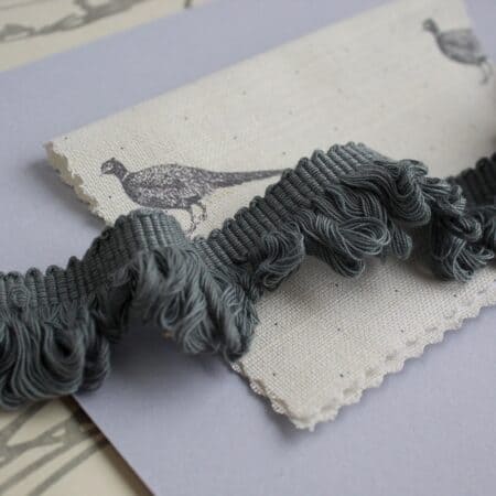 Grey hand made edging with cream fabric with bird pattern