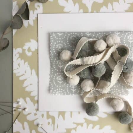 white and grey pom poms with fabric samples