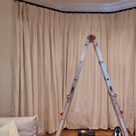 ladder ready to measure and install with white curtains