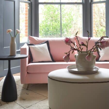 pink sofa with white cushions