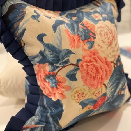 cream, navy blue and pink rose pattern cushion with Nay blue trim
