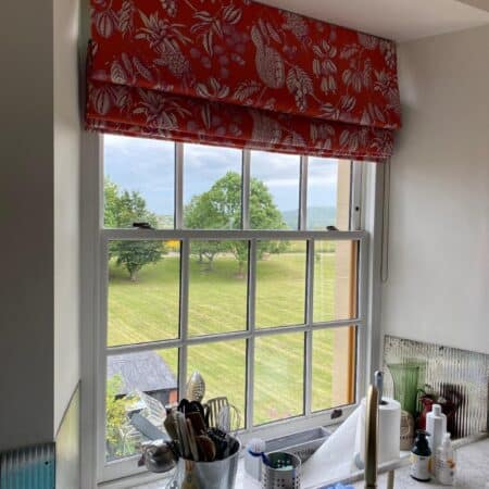 Red blind with white floral pattern