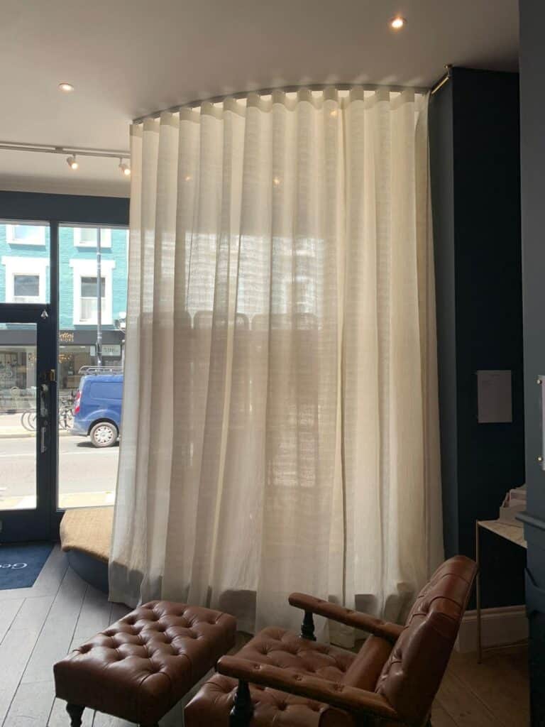 white sheer curtains in a shop window